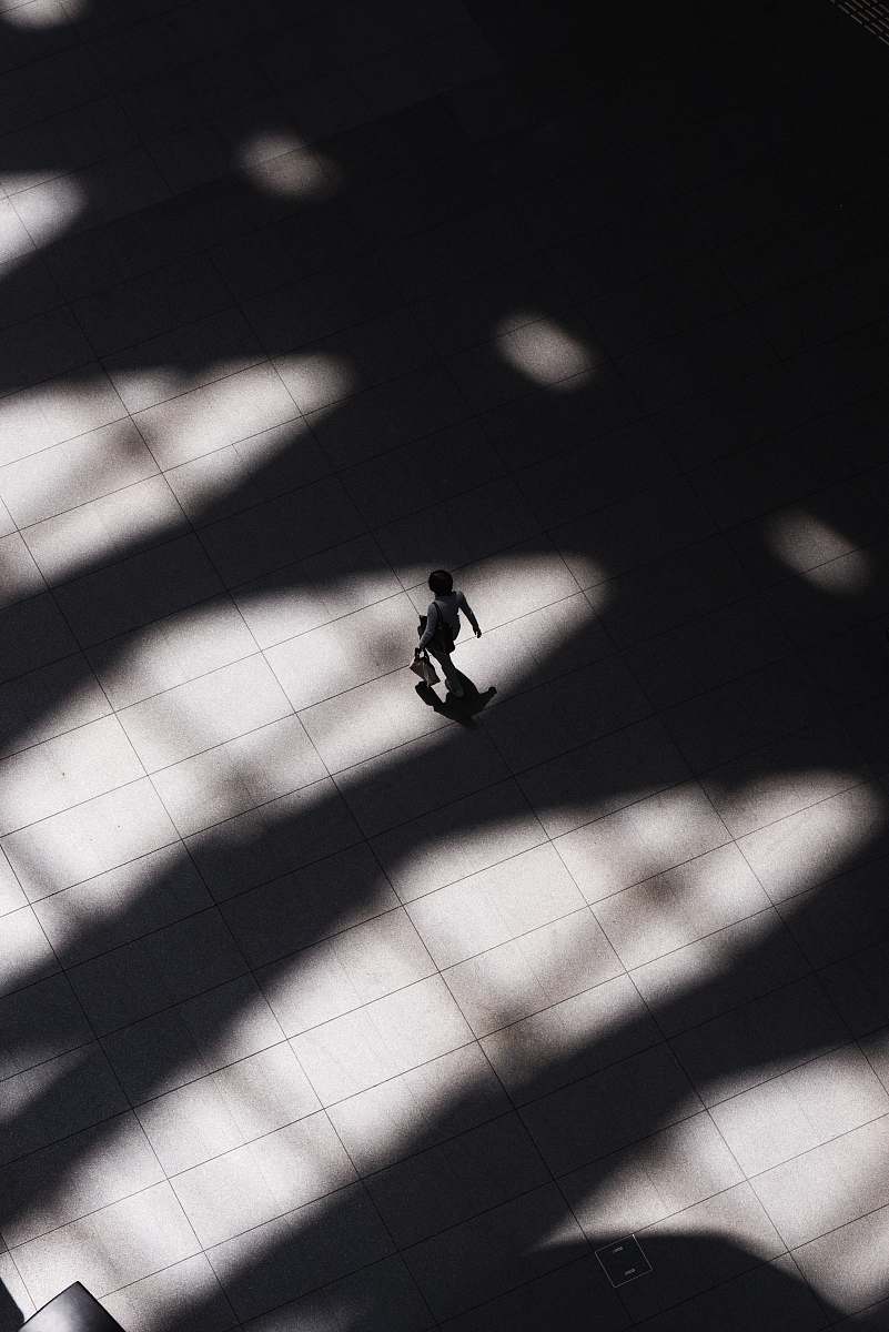 tokyo international forum woman walking on white tiled flooring chiyoda-ku
